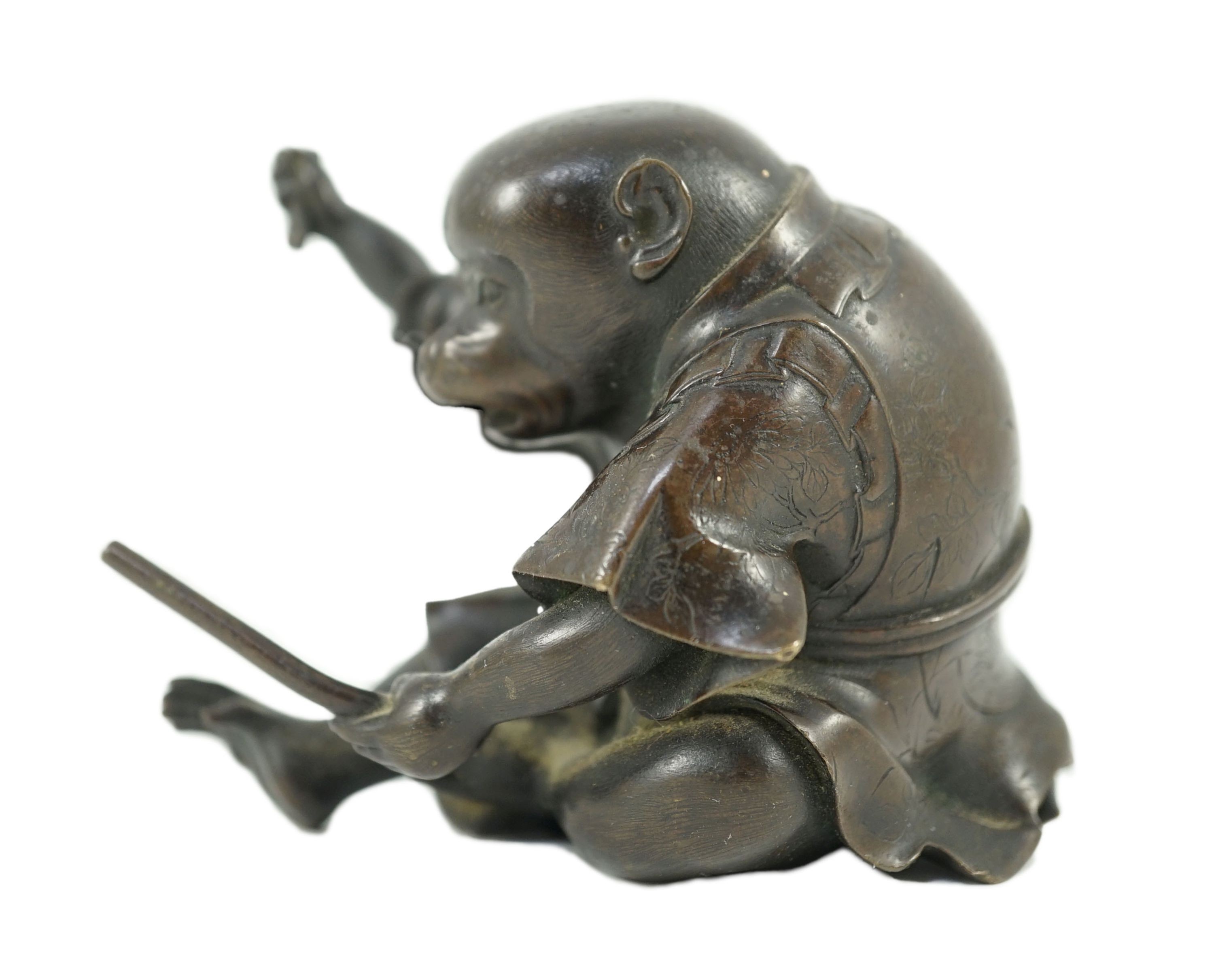A Japanese bronze figure of a monkey, 19th century, 6cms high.